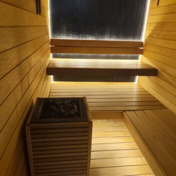 HUUM electric sauna heater inside a wooden sauna – SmithTech Ltd sauna repair, installation and servicing in London.